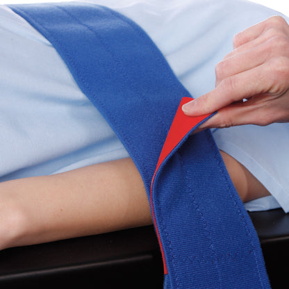 A person attaches the AliMed Universal Strap, One-Piece, One Closure, No Side Rail, using a blue strap with a red underside.