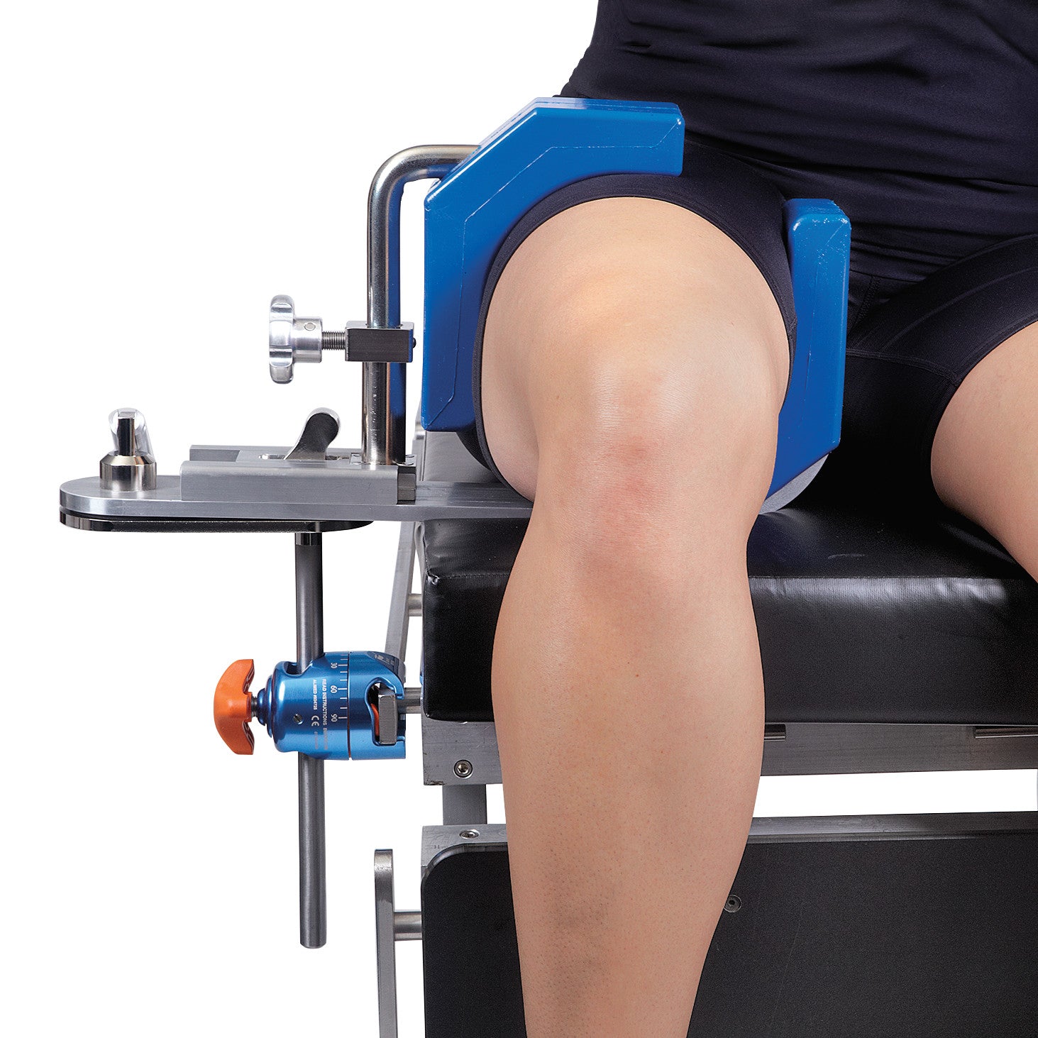 A person's leg is secured in an AliMed Fluid-Proof Arthroscopic Leg Holder, featuring a blue padded support and metal adjustments.