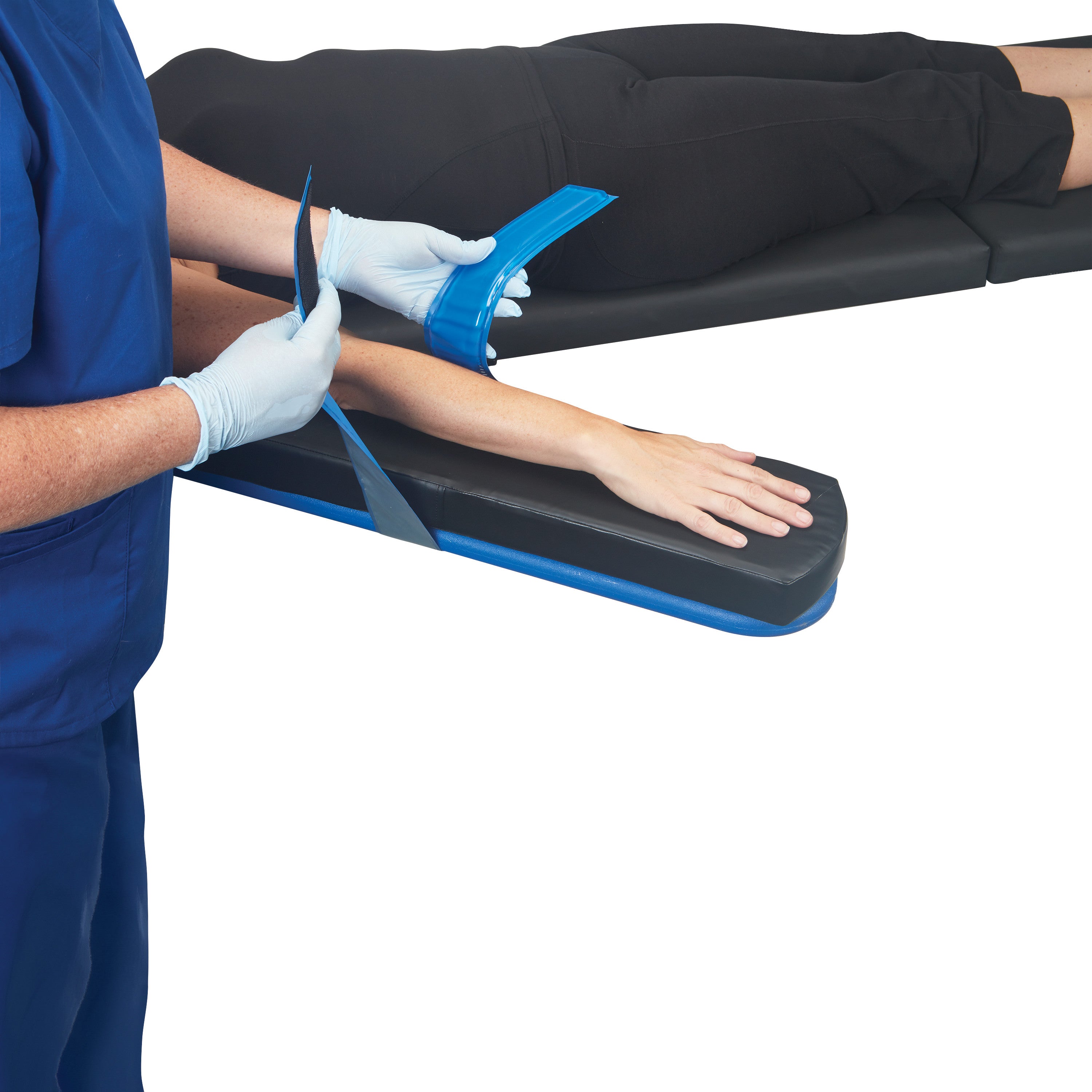 A person secures an arm with an AliMed AliBlue Gel Armboard Strap, designed for comfortable positioning on an armboard.