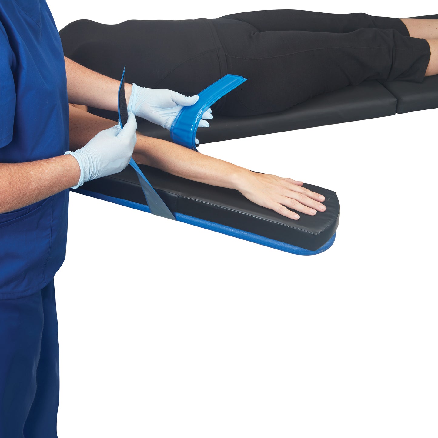 A person secures an arm with an AliMed AliBlue Gel Armboard Strap, designed for comfortable positioning on an armboard.