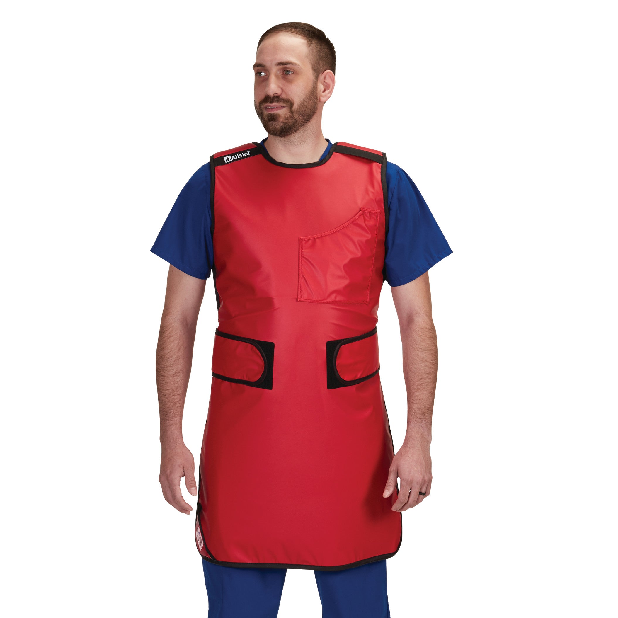 Man wears AliMed Grab n Go 4-Point Quick Drop Apron, Male in red over blue scrubs, designed for easy removal.