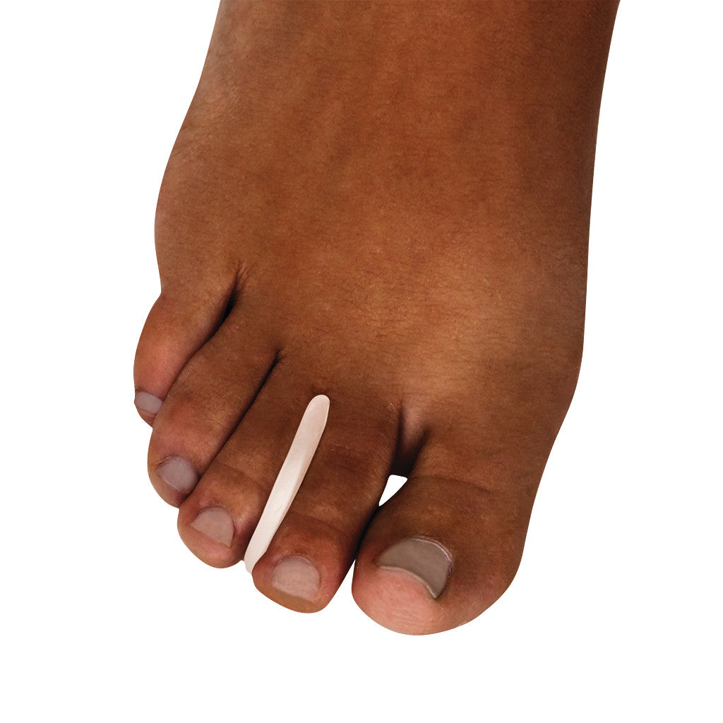 A foot wearing a Silipos Gel Toe Separator between the toes. The separator helps alleviate discomfort and align toes.