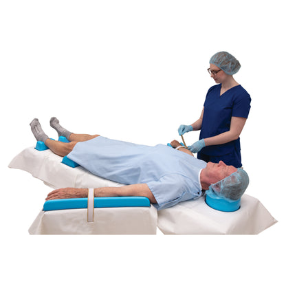 A healthcare worker adjusts a patient's arm on an AliMed AliBlue Lite Hybrid Gel Contoured Armboard Pad in a medical setting.