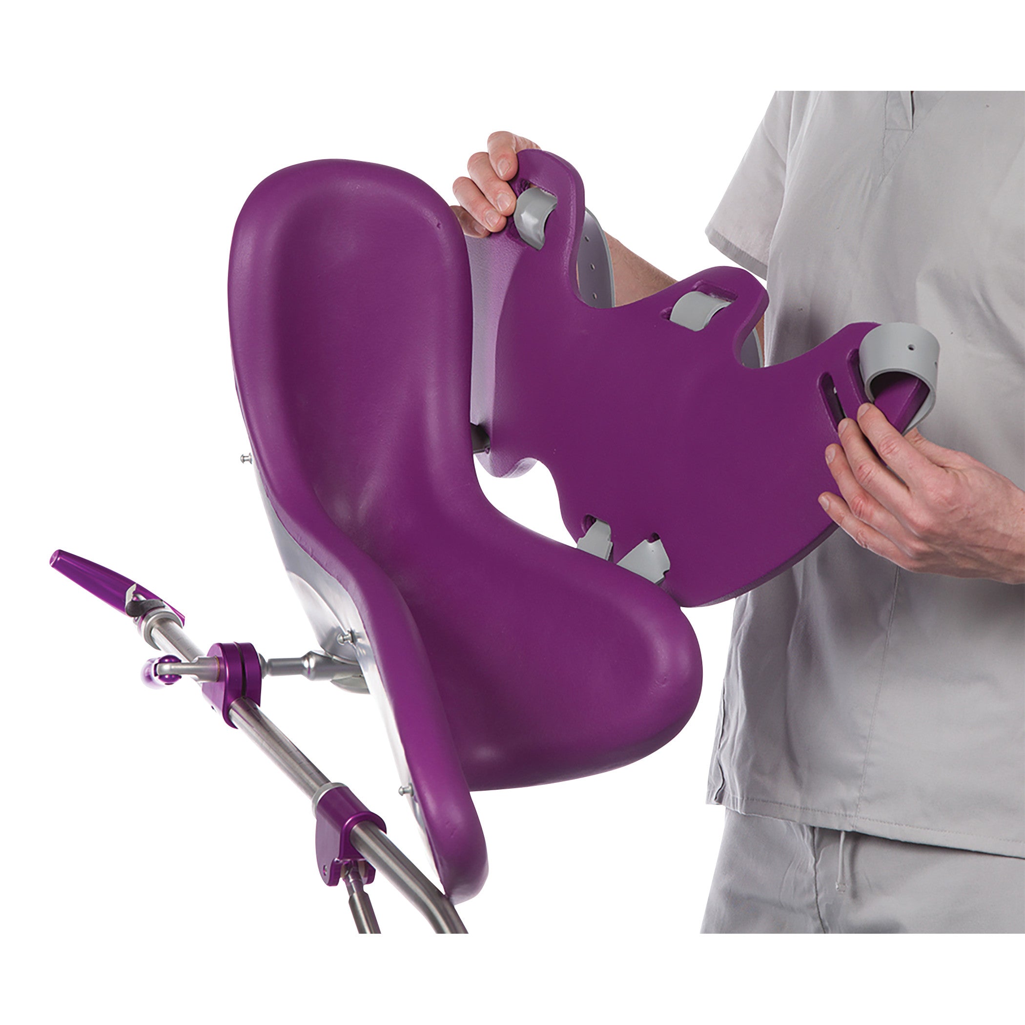 A person adjusts the KYRA Clean 350 Lithotomy Stirrup, featuring a purple ergonomic design and metallic support structure.