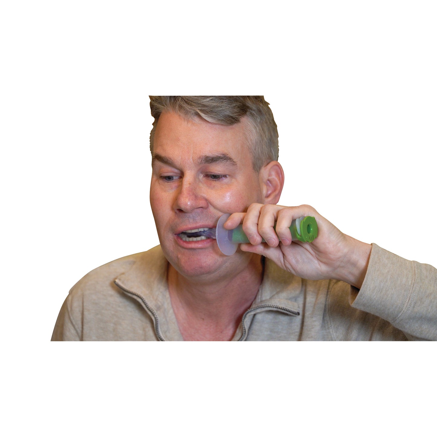 A man uses The Side Biter Chewing and Swallowing Therapy System, holding a green-handled tool against his cheek.