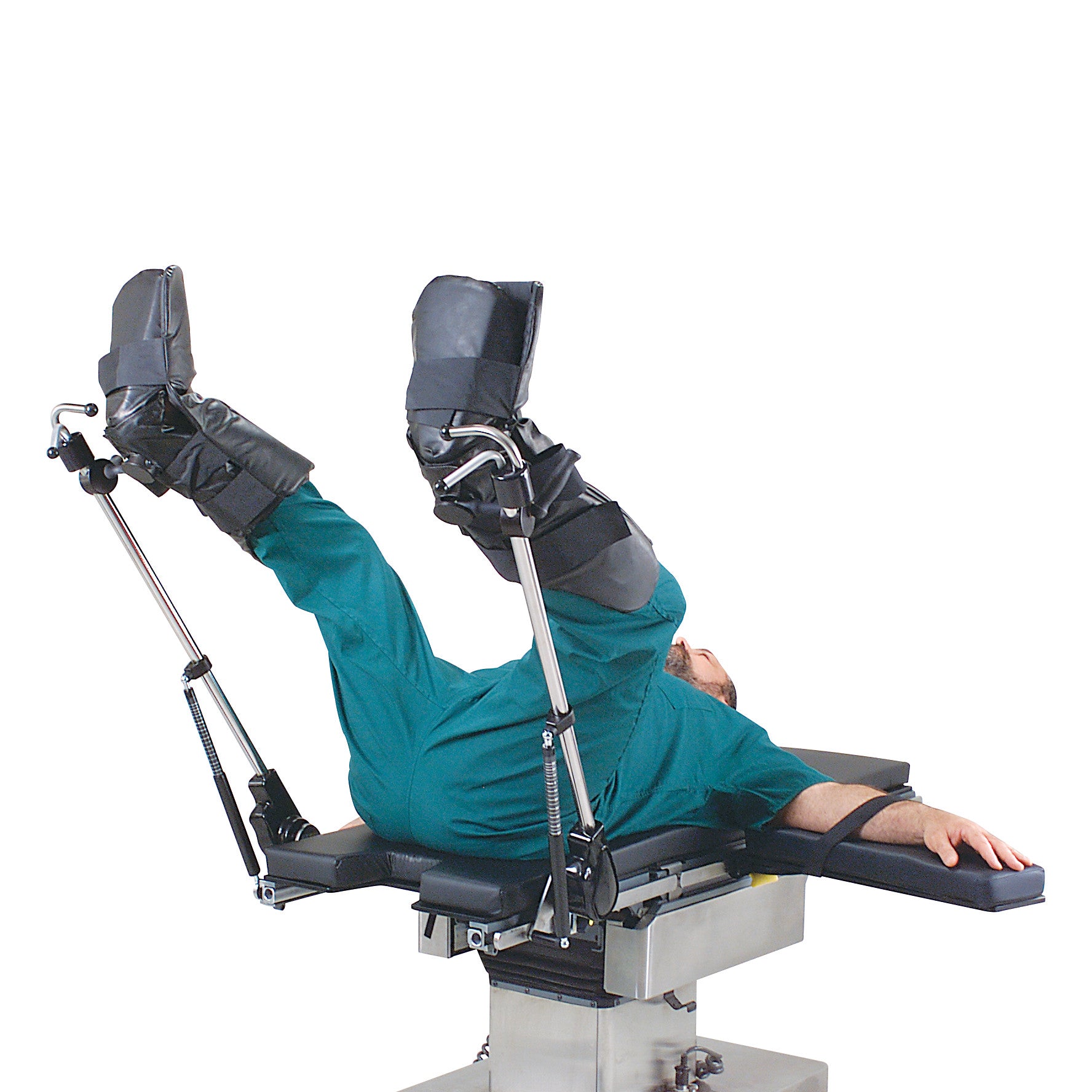 Person lying on a surgical table with legs supported in Allen Ultrafin Stirrups, wearing green scrubs and black boots.