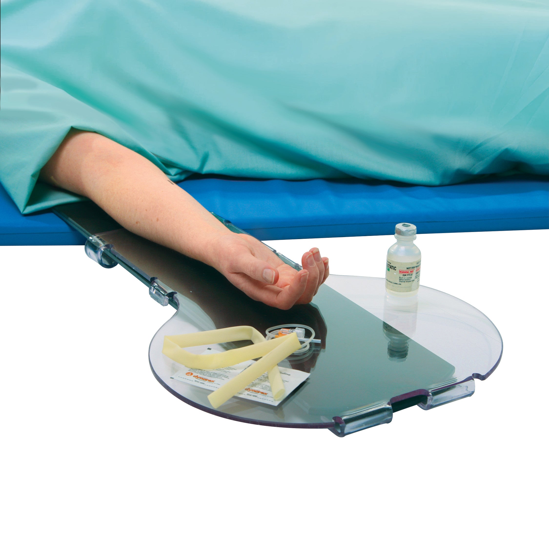 A person's arm rests on an AliMed Universal Armboard Width Extender with medical supplies nearby, including a vial and tubing.