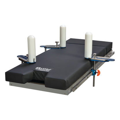 The AliMed Lateral Positioner Set is a medical device with a padded surface and four cylindrical supports for patient stabilization.