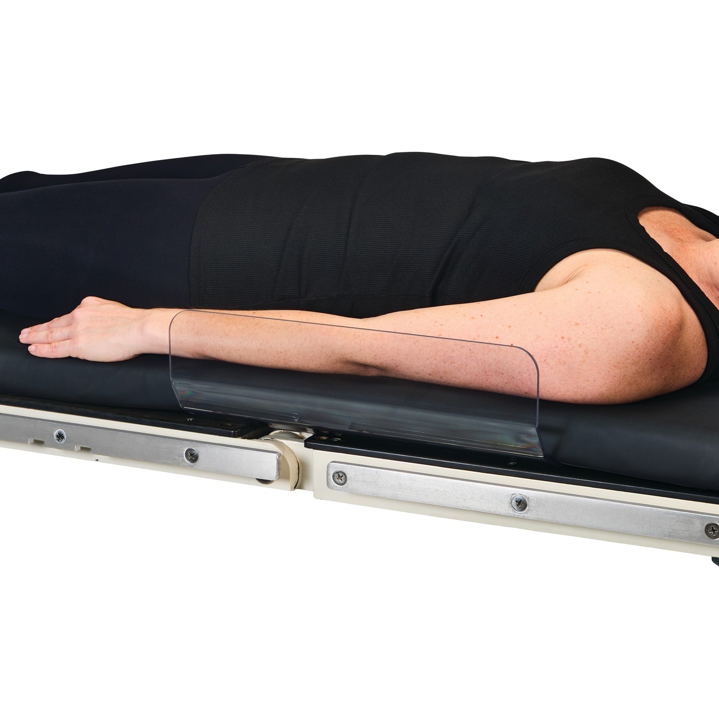 A patient lies on a table with an AliMed Low-Profile Toboggan Arm/Leg Guard securing the arm, shown in a side profile view.