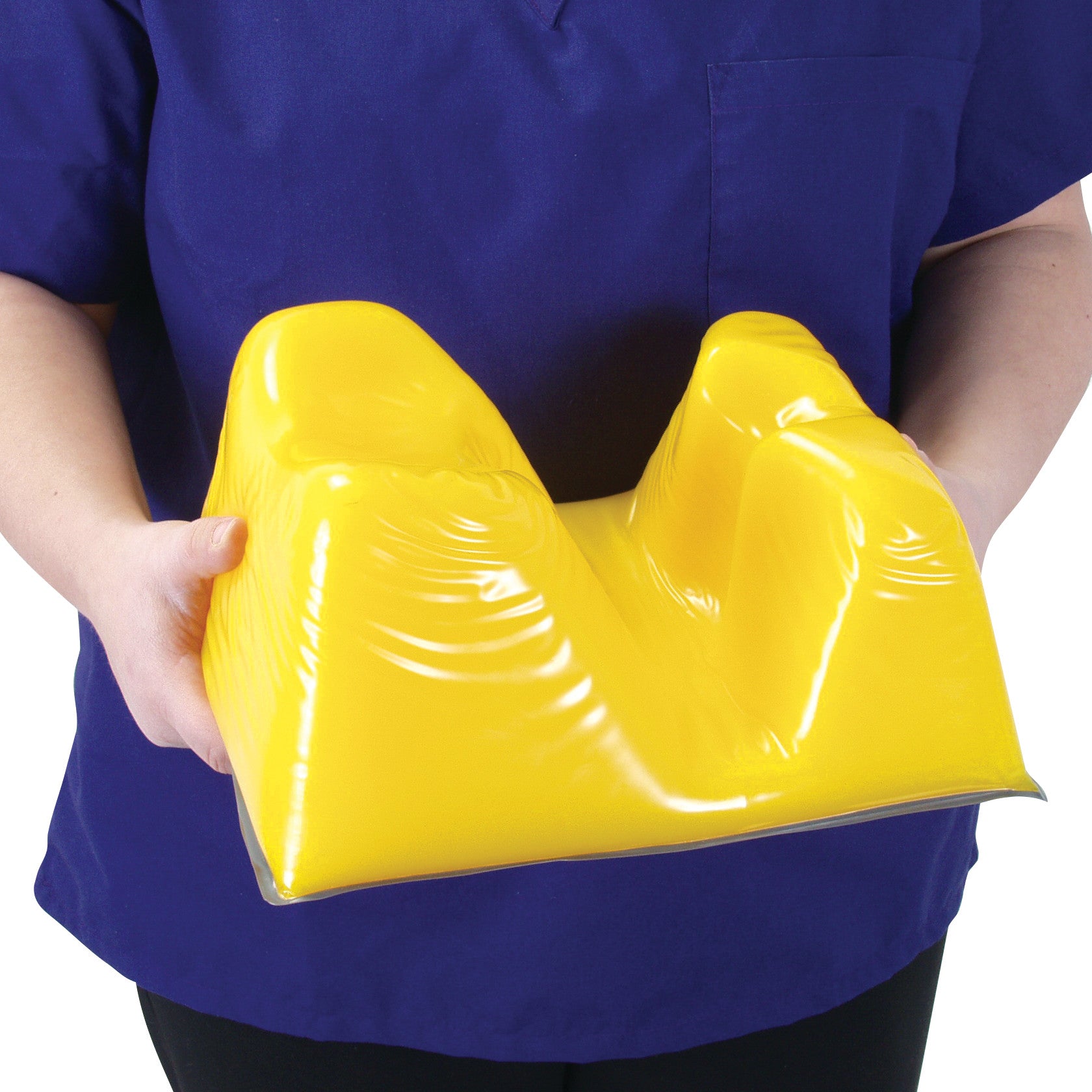 Person holding a yellow AliMed AliLite Prone Headrest, designed to support the head during prone positioning.