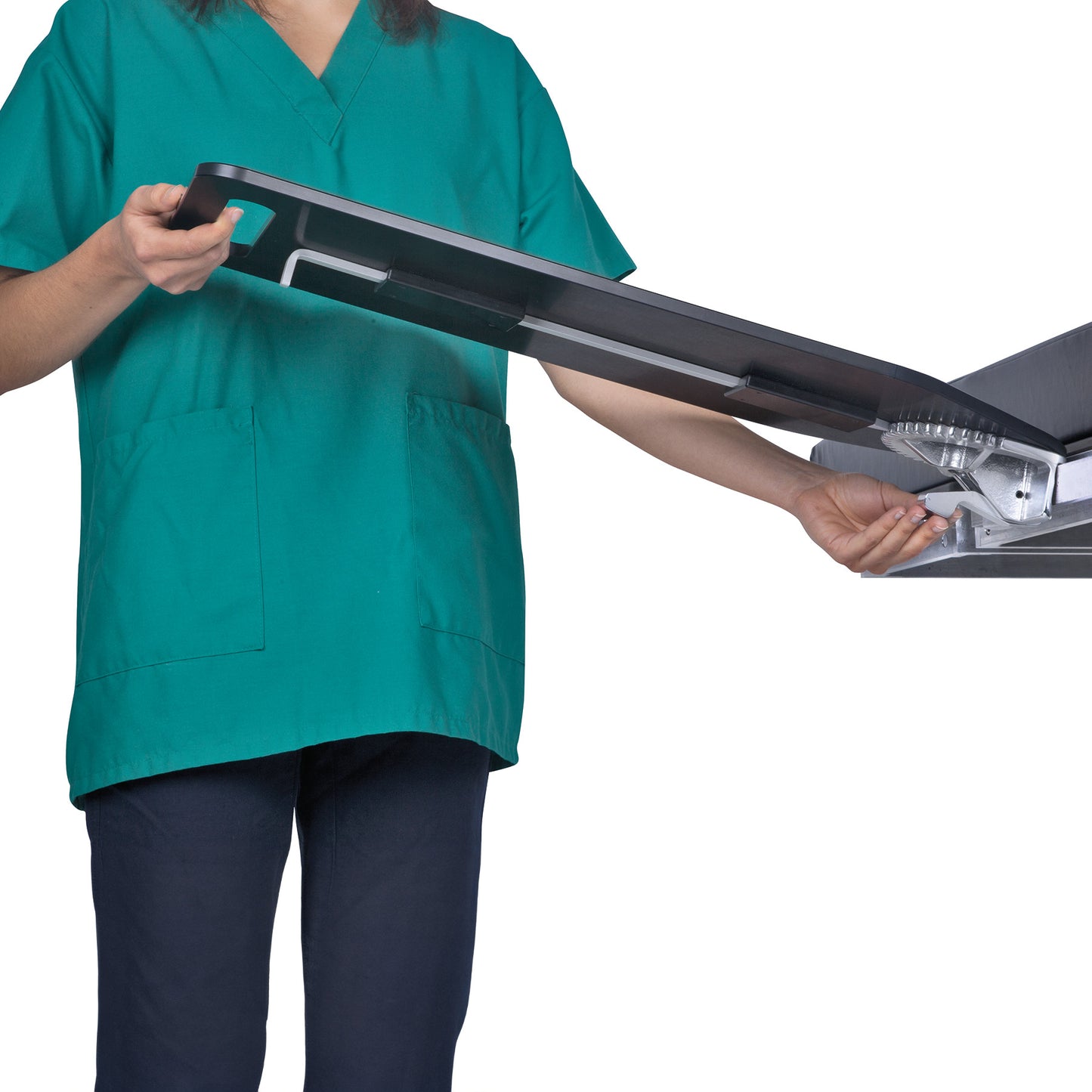A person adjusts an AliMed Pivoting Armboard, wearing green medical scrubs. The armboard is partially extended.
