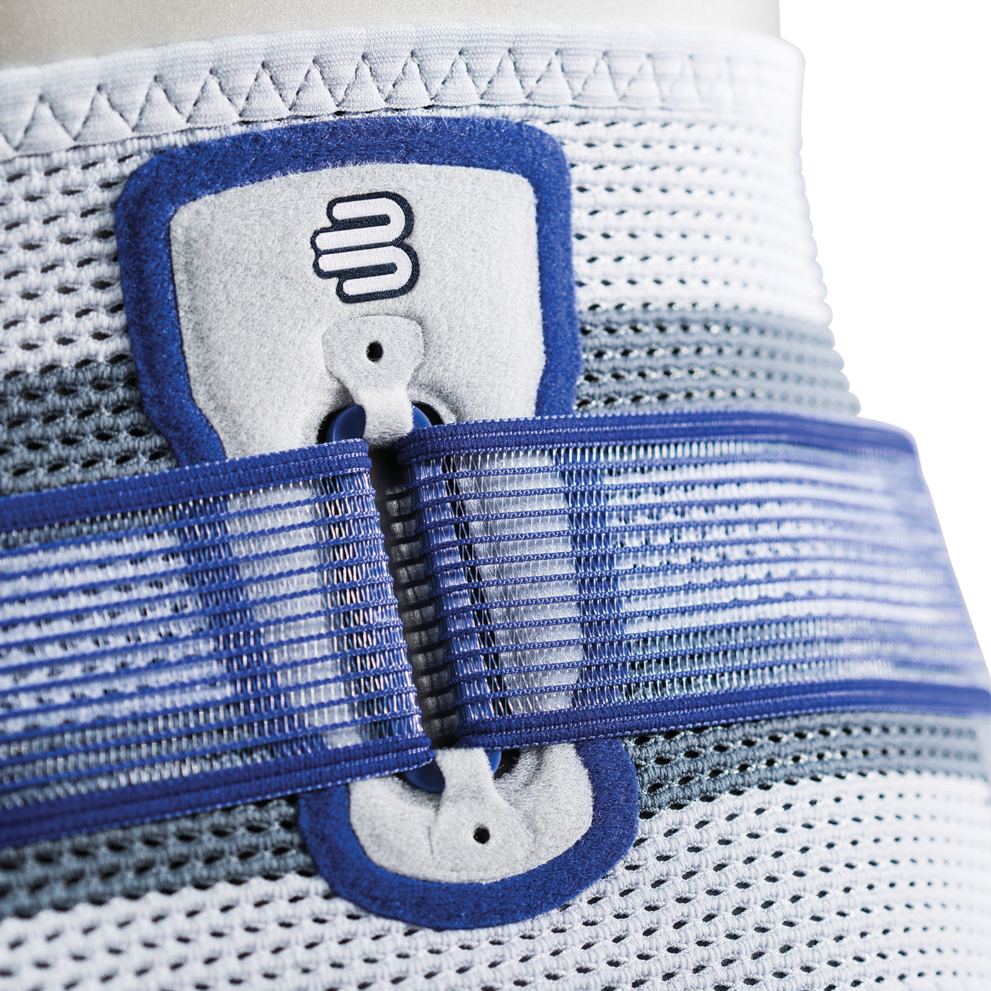 Close-up of the Bauerfeind SacroLoc, featuring a blue and gray mesh support structure with adjustable straps and a branded logo.