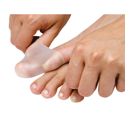 Hands place a PediFix Visco-GEL All-Gel Toe Cap on a big toe, providing cushioning and protection.