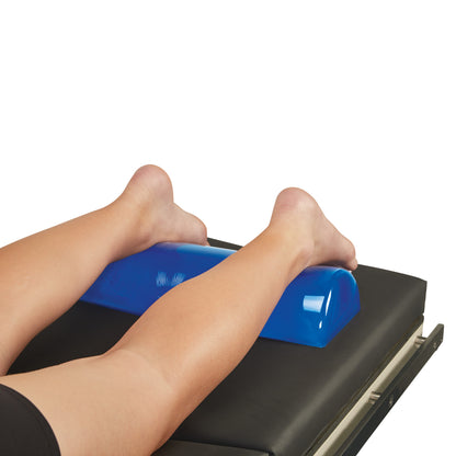 Legs rest on the AliMed AliBlue Gel Dome Positioner, placed on a black surface for optimal support.