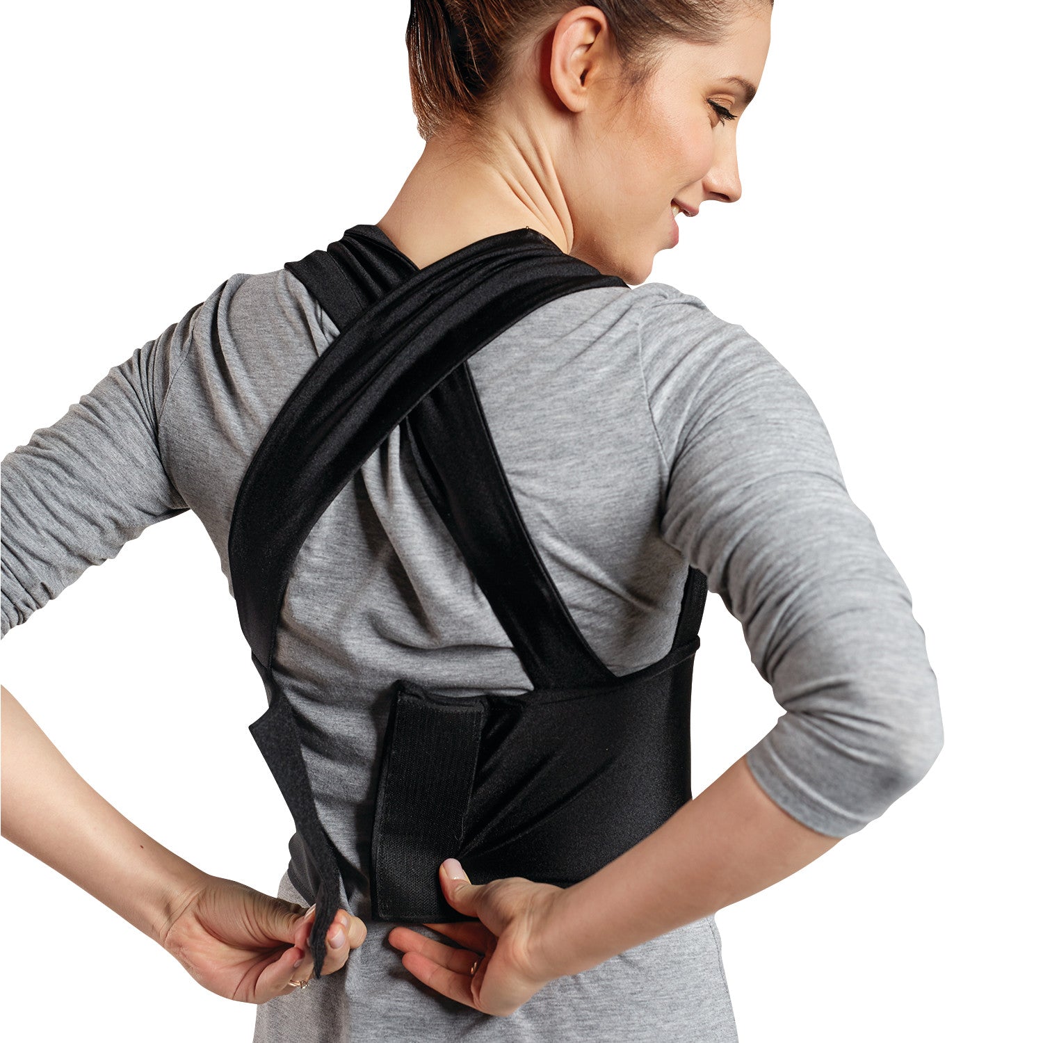 A person wearing the Femi Posture back support, adjusting the black straps over a gray shirt.