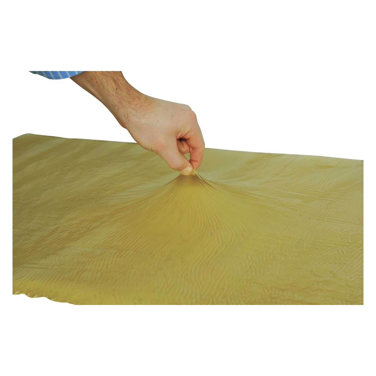 A hand pinching the surface of the AliMed T-Gel Mattress Topper, displaying its stretchy and textured yellow material.