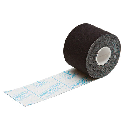 A roll of black Kinesio Tex Gold FP Tape is partially unrolled, showing the adhesive backing with printed markings.