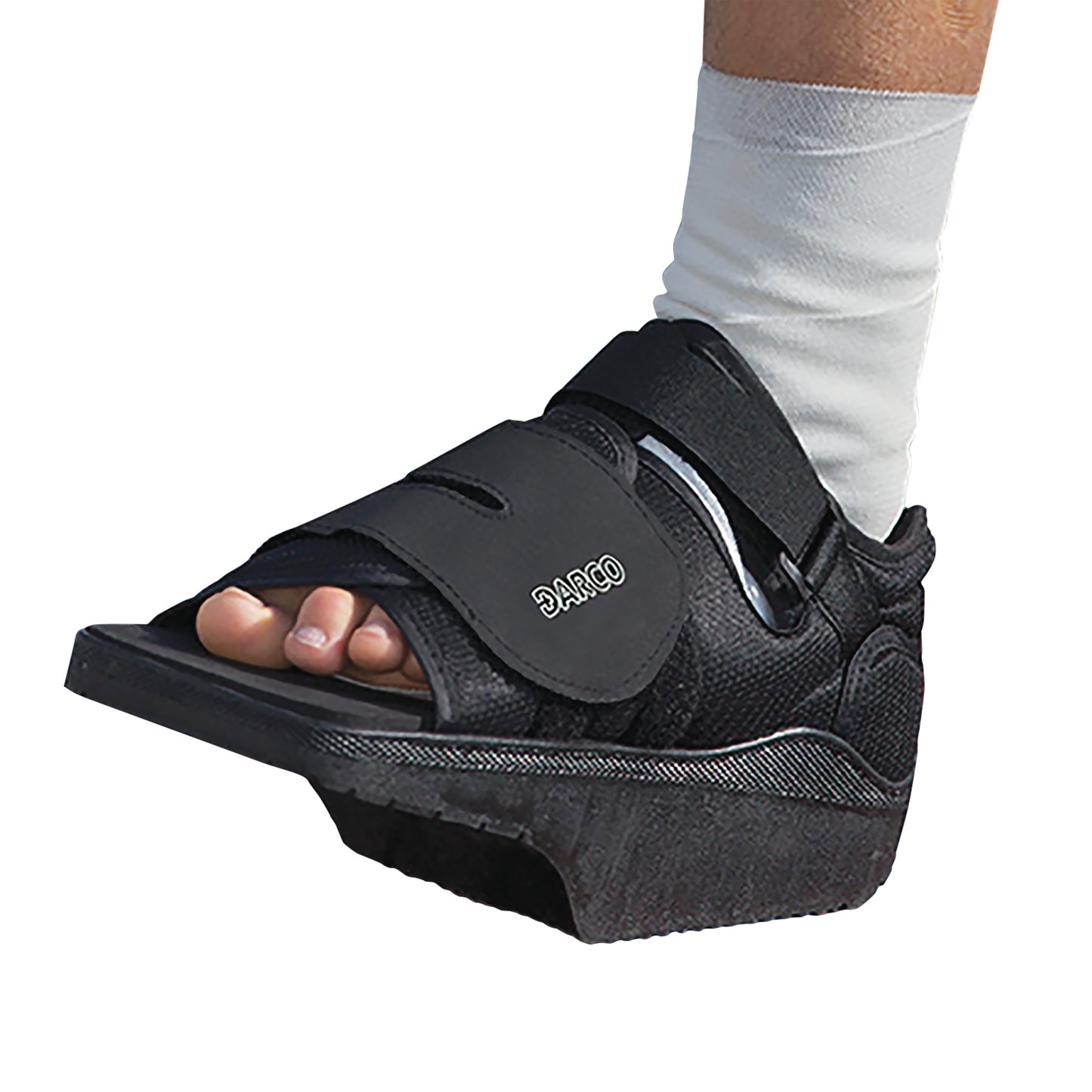 A foot wearing a DARCO OrthoWedge Shoe with open toes and straps, designed for post-operative care.