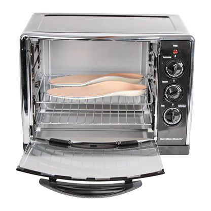 A pair of shoe insoles is placed inside an open Convection Oven, which has controls for temperature, function, and timer on the side.