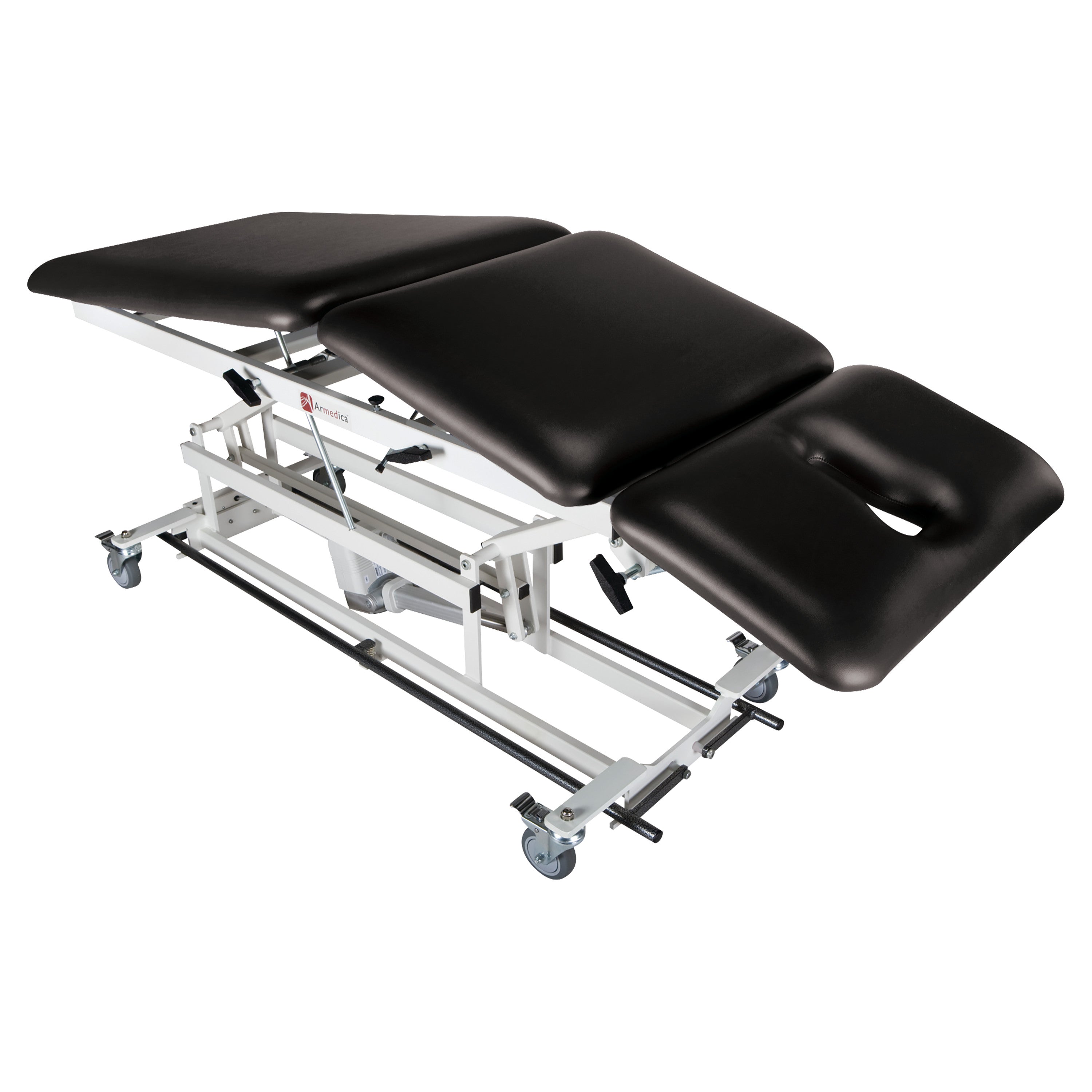 Armedica AM-BA300 Treatment Table with black cushioned sections, adjustable angles, face opening, and caster wheels.