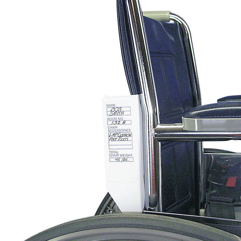 A wheelchair with a Safe-t mate Wheelchair Labeling System, displaying handwritten details like name, room number, and chair weight.