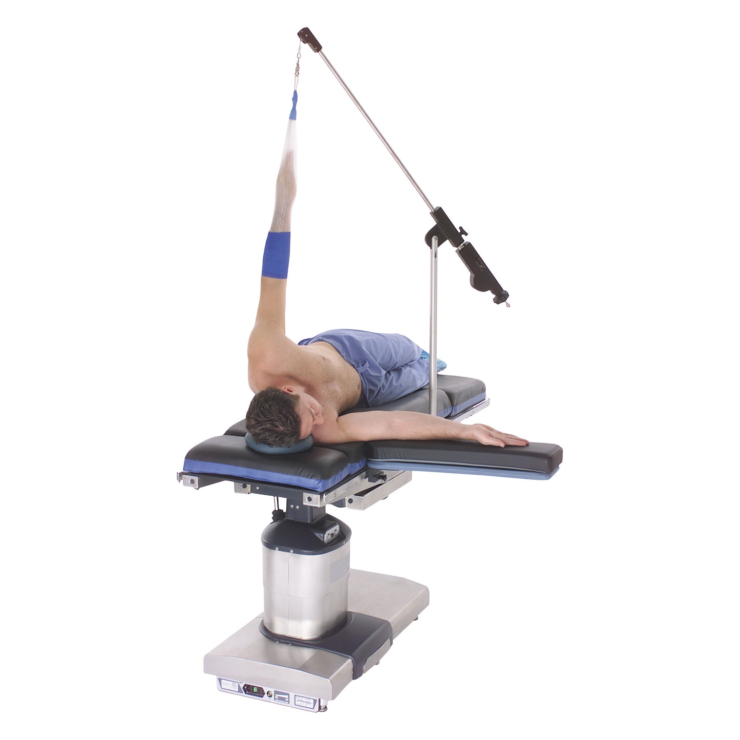 A person is lying on a medical table with an arm supported by the Weightless Shoulder Suspension System, wearing a blue sleeve.