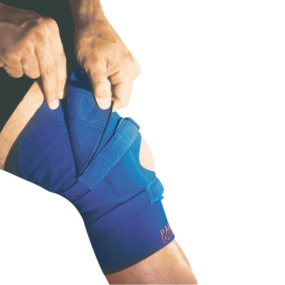 A person adjusts a blue Palumbo Knee Brace with Adjustable Thigh, securing it around their knee with straps.