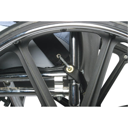 A close-up of a wheelchair's wheel and frame, showing the AliMed UniLoop Seatbelt Attachment secured to the frame with a hook.