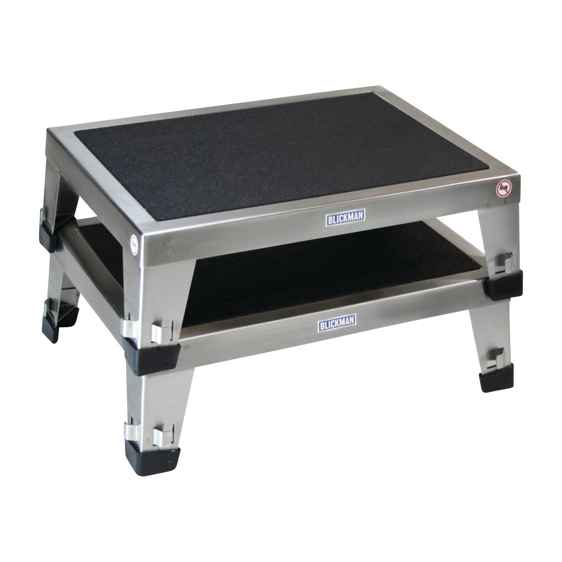 Two Blickman EZ Stacking Stools, with metal frames and black surfaces, stacked on top of each other.