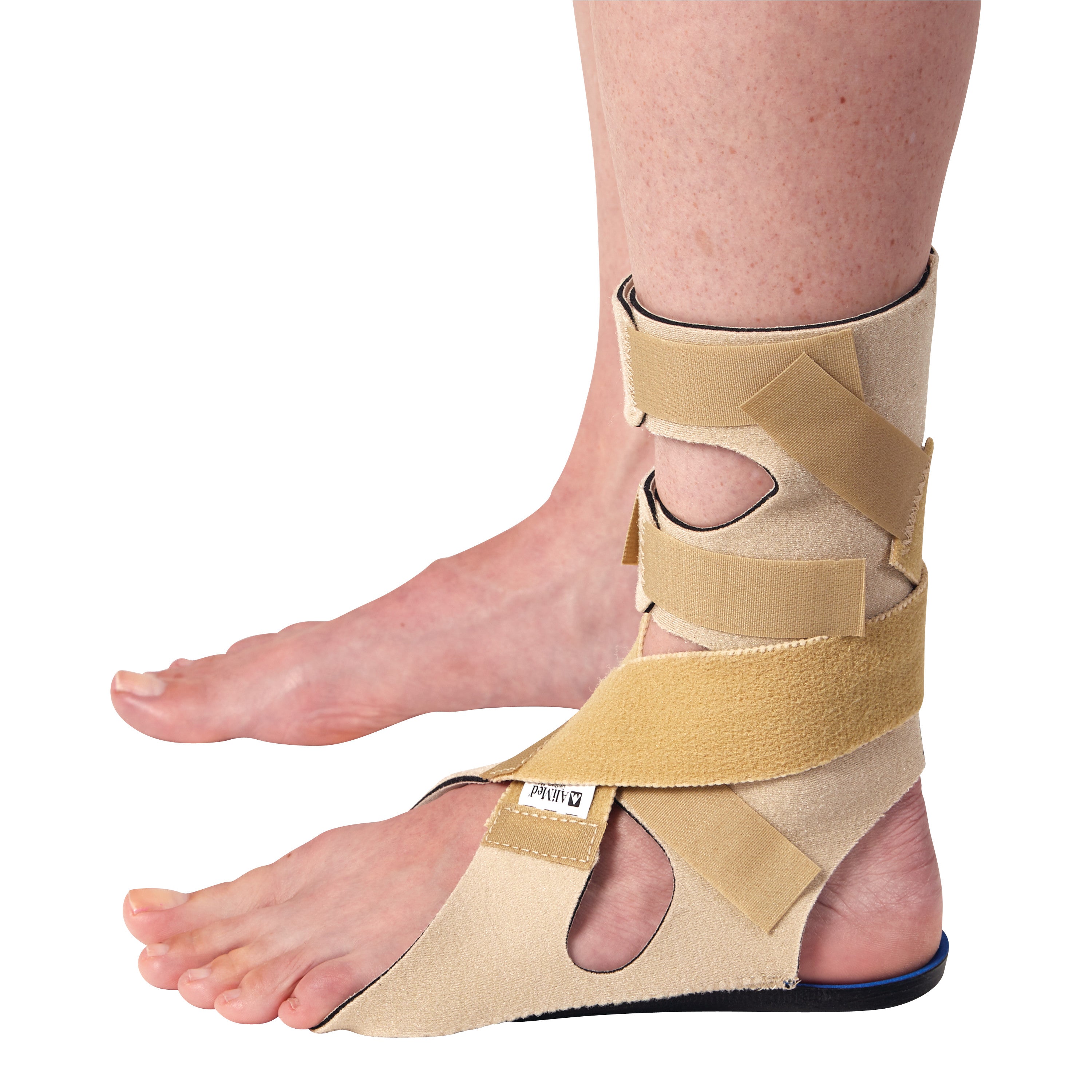 The AliMed FREEDOM Soft Footdrop Brace is shown worn on a foot. It has beige straps providing support around the ankle and foot.