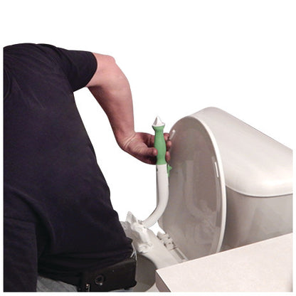 A person uses the FreedomWand, a personal hygiene aid, near a toilet. The green-handled tool is held in the hand.