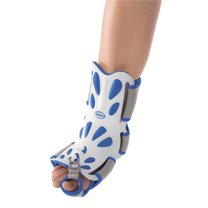 An adult leg wearing a DARCO Body Armor Night Splint in white and blue, designed to support the foot, ankle, and lower leg.