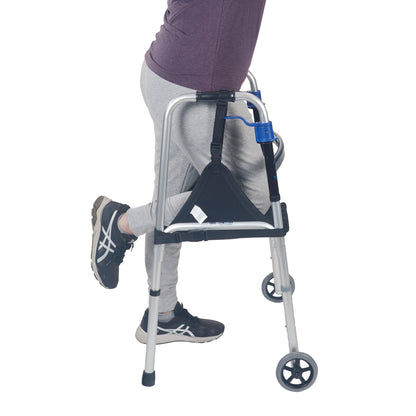 Person using a walker with a "SafetySure The Knee Sling" attached, supporting their bent knee.