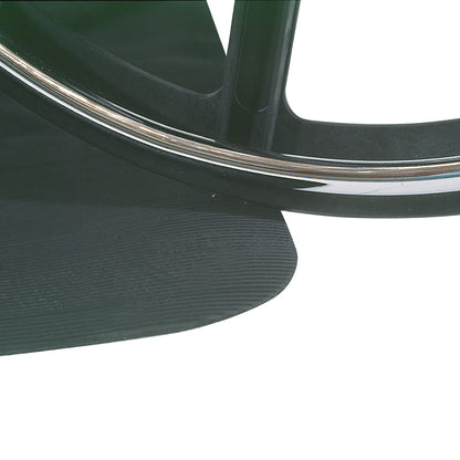 Close-up of a black AliMed Safety NoSlip Mat with textured surface, partially covered by a wheelchair wheel with a metal rim.