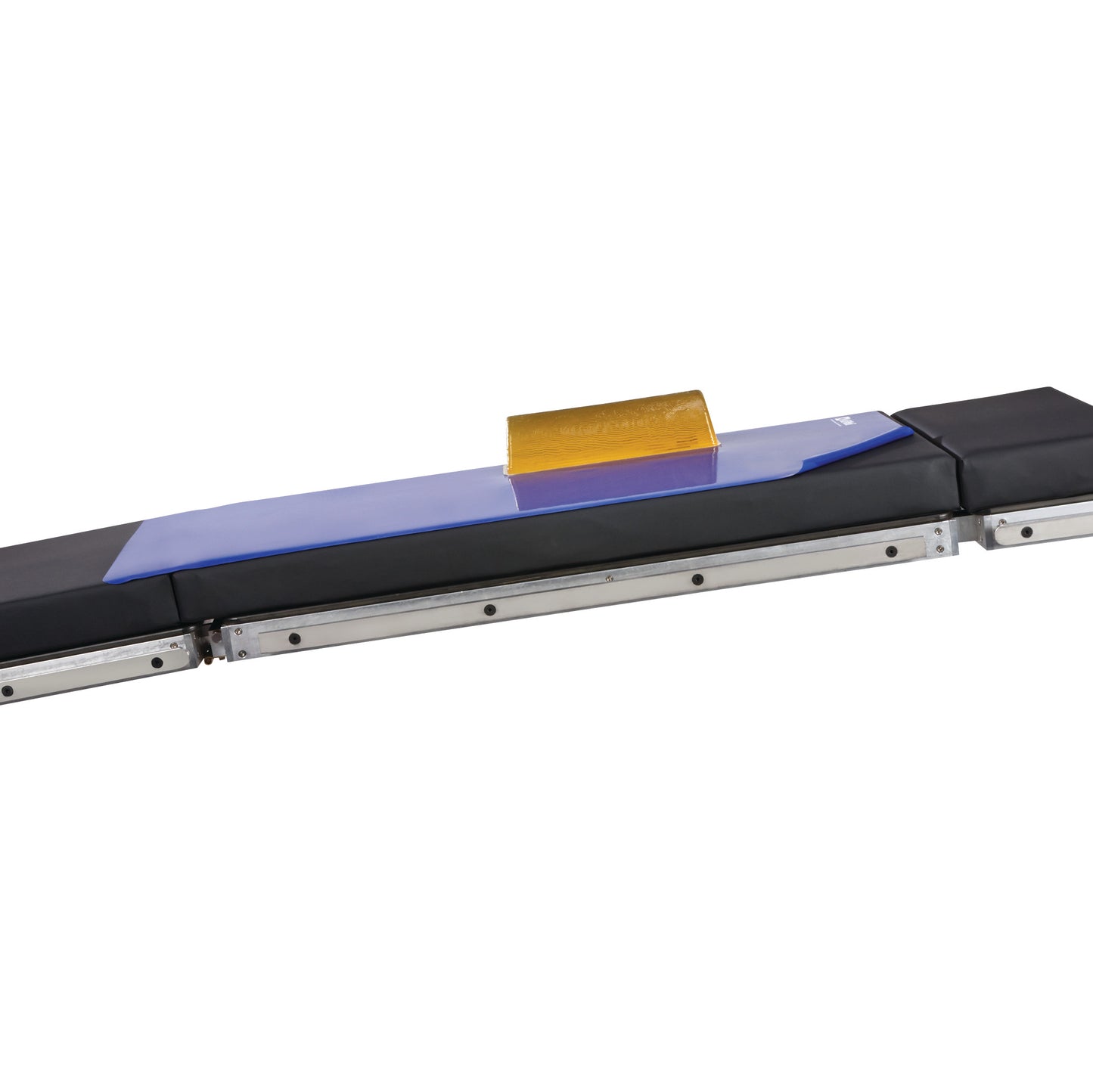 The AliMed Nonslip Surface Overlay placed on a medical table, featuring a blue overlay with a yellow grip block.