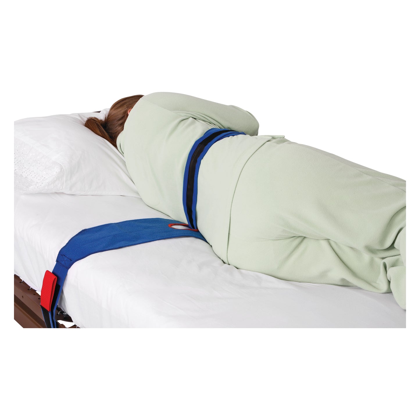 Person laying on a bed wearing an AliMed Roll-Control Belt, which secures them with blue straps and a pillow under their head.