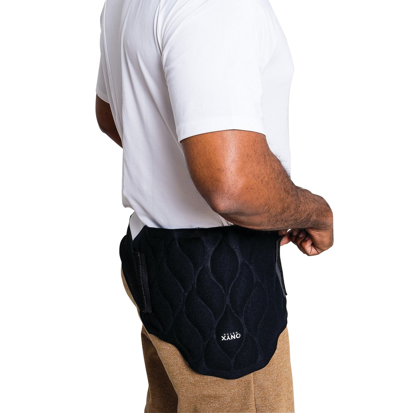 A person wearing the Xena Therapies Onyx Cool Back/Hip wrap, a quilted black support around the lower back and hip area.