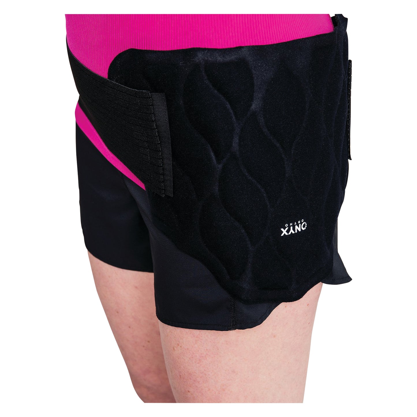 Person wearing the Xena Therapies Onyx Cool Back/Hip wrap over black shorts and a pink shirt.