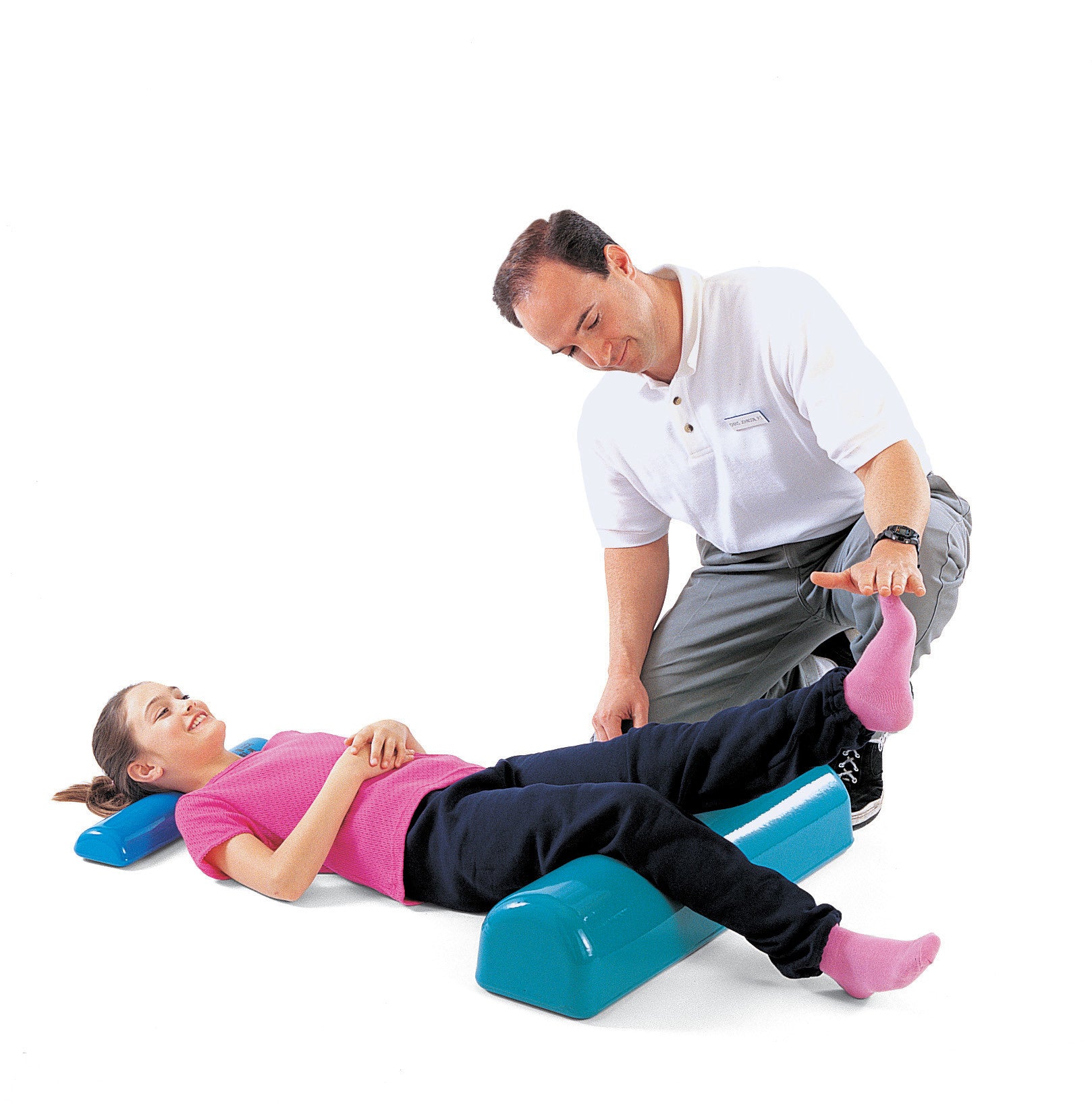 A child lies on a Tumble Forms2 Half Roll while an adult assists with leg exercises. The half roll is blue.