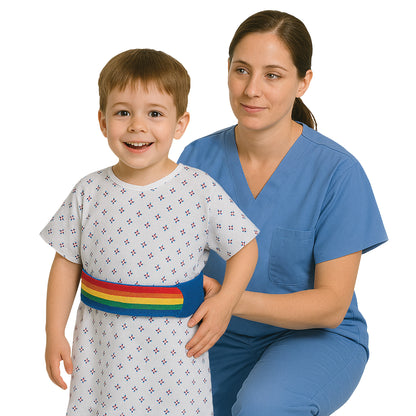 A woman in blue scrubs helps a smiling child wearing an AliMed Pediatric Walker Belt and patterned gown.