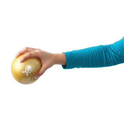 A hand in a blue sleeve grips a yellow CanDo Hand WaTE Ball. The ball features its logo, and the background is white.