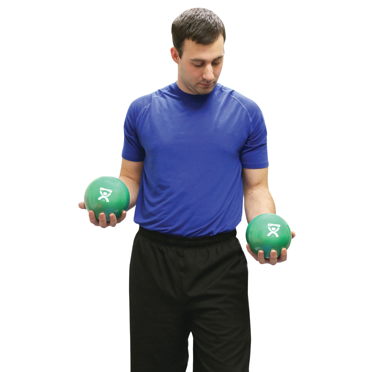 A person holding two CanDo Hand WaTE Balls, green exercise balls, wearing a blue shirt and black pants, on a white background.
