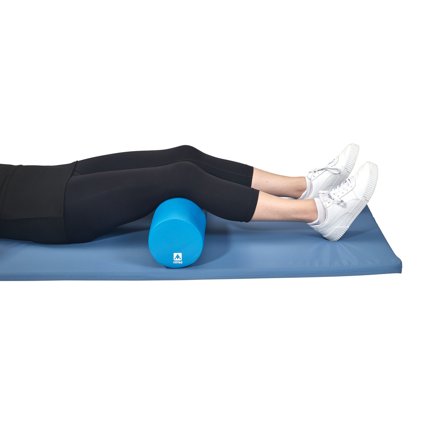 Person using the AliMed Antimicrobial-Treated Therapy Positioning Roll under their knees while lying on a blue mat.