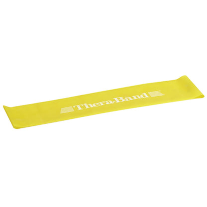 A yellow THERABAND Resistance Band Loop lies flat. It has the brand name and logo printed in white on the surface.