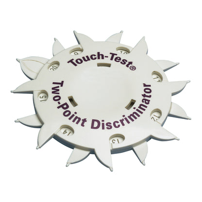 The Touch-Test Two-Point Discriminator is a wheel-shaped medical tool with numbered spikes for sensory evaluation.