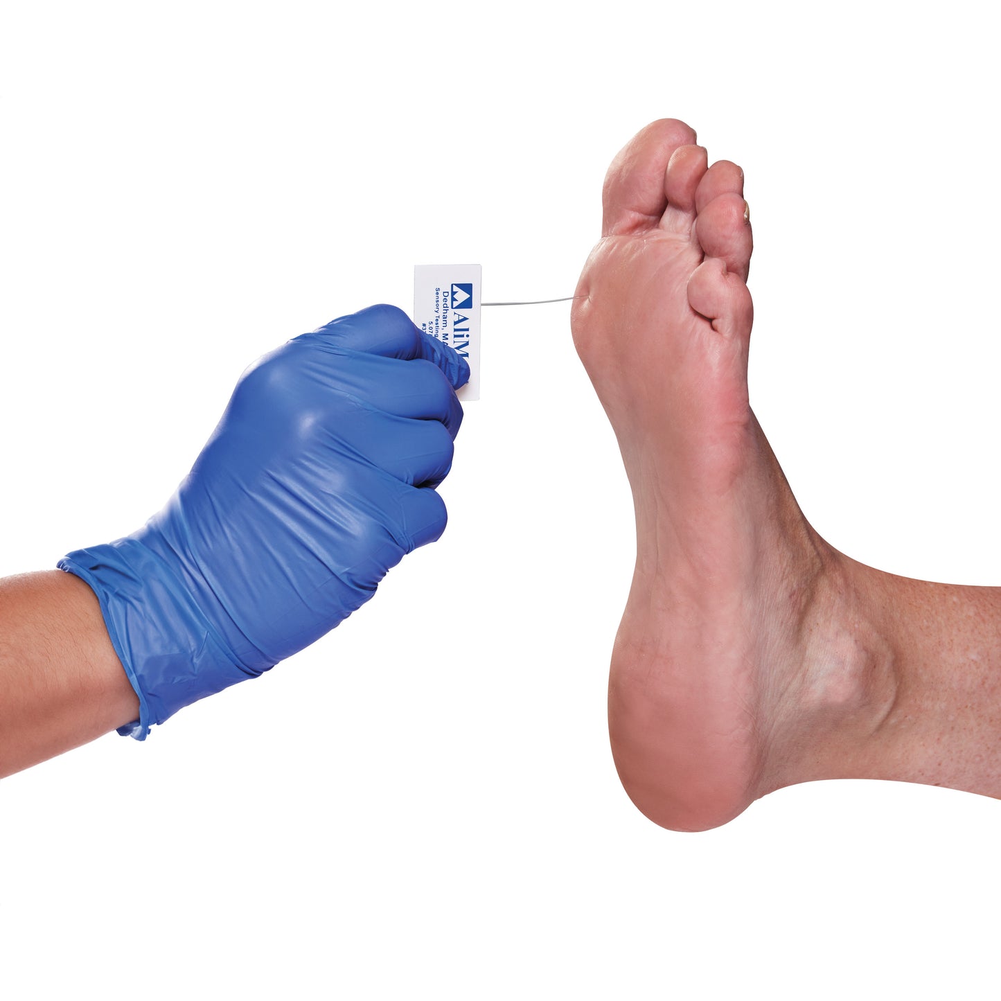 A gloved hand uses an AliMed Disposable Monofilament to test sensation on the underside of a person's foot.