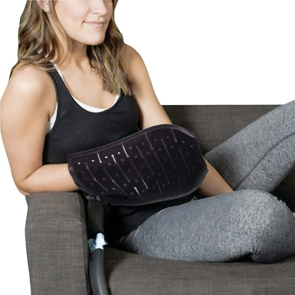 A woman uses the Mitt for Pain Management Technologies Hot/Cold Therapy Aqua Relief System, sitting on a couch.