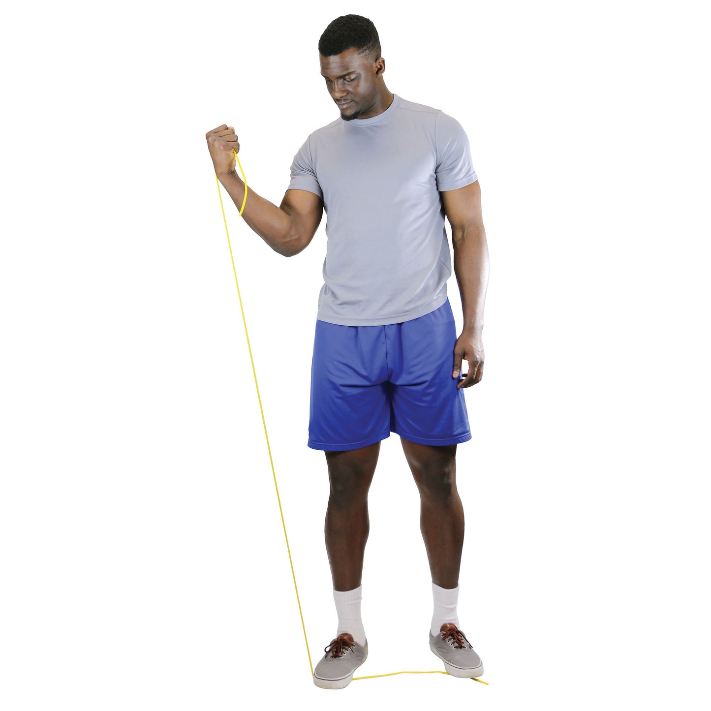 A person exercises with yellow CanDo Exercise Tubing, wearing a gray shirt and blue shorts. The tubing is under one foot.
