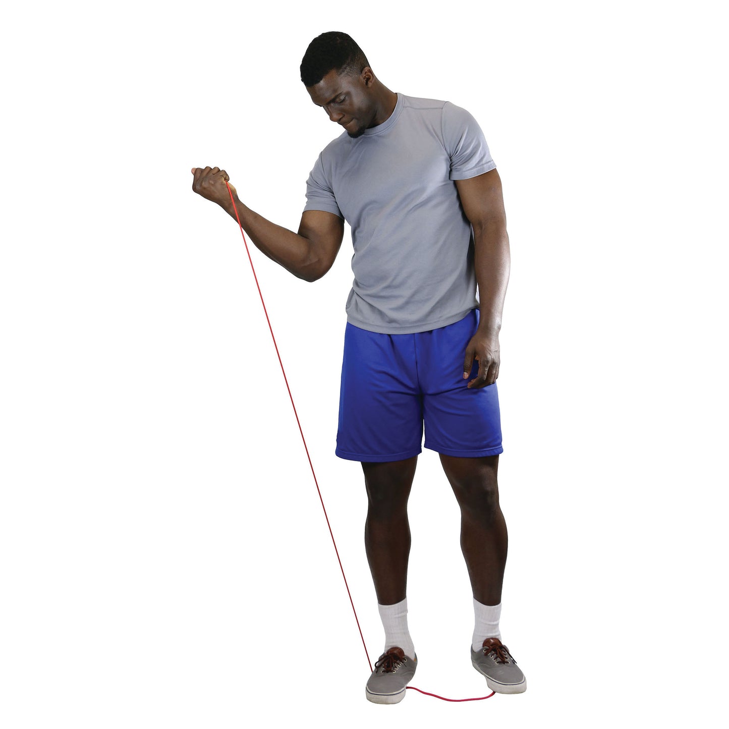 A man exercises with red CanDo Exercise Tubing, wearing a gray shirt, blue shorts, socks, and shoes on a white background.