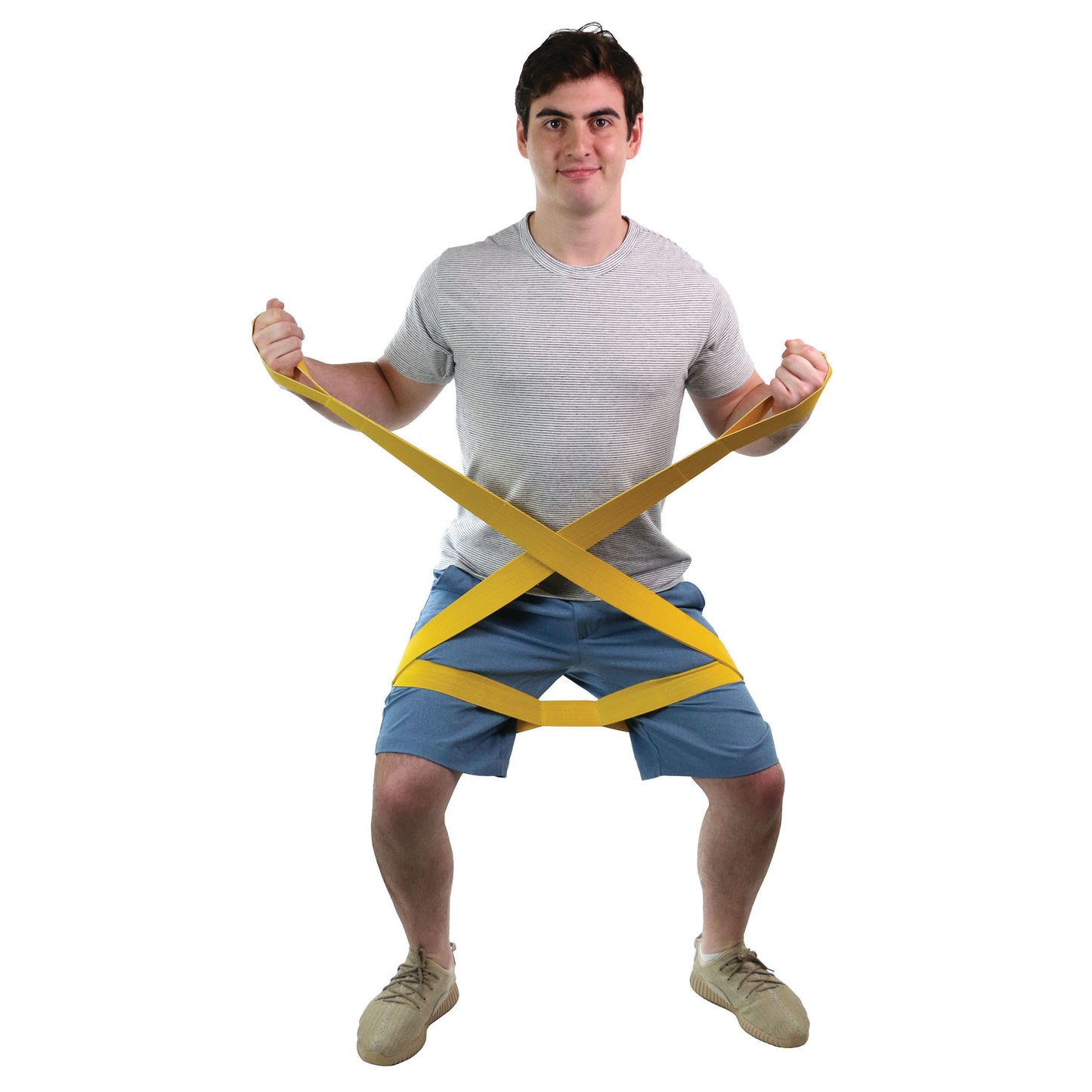 A person squats using a CanDo Multi-Grip Exerciser, a yellow resistance band wrapped around their legs and held in hands.